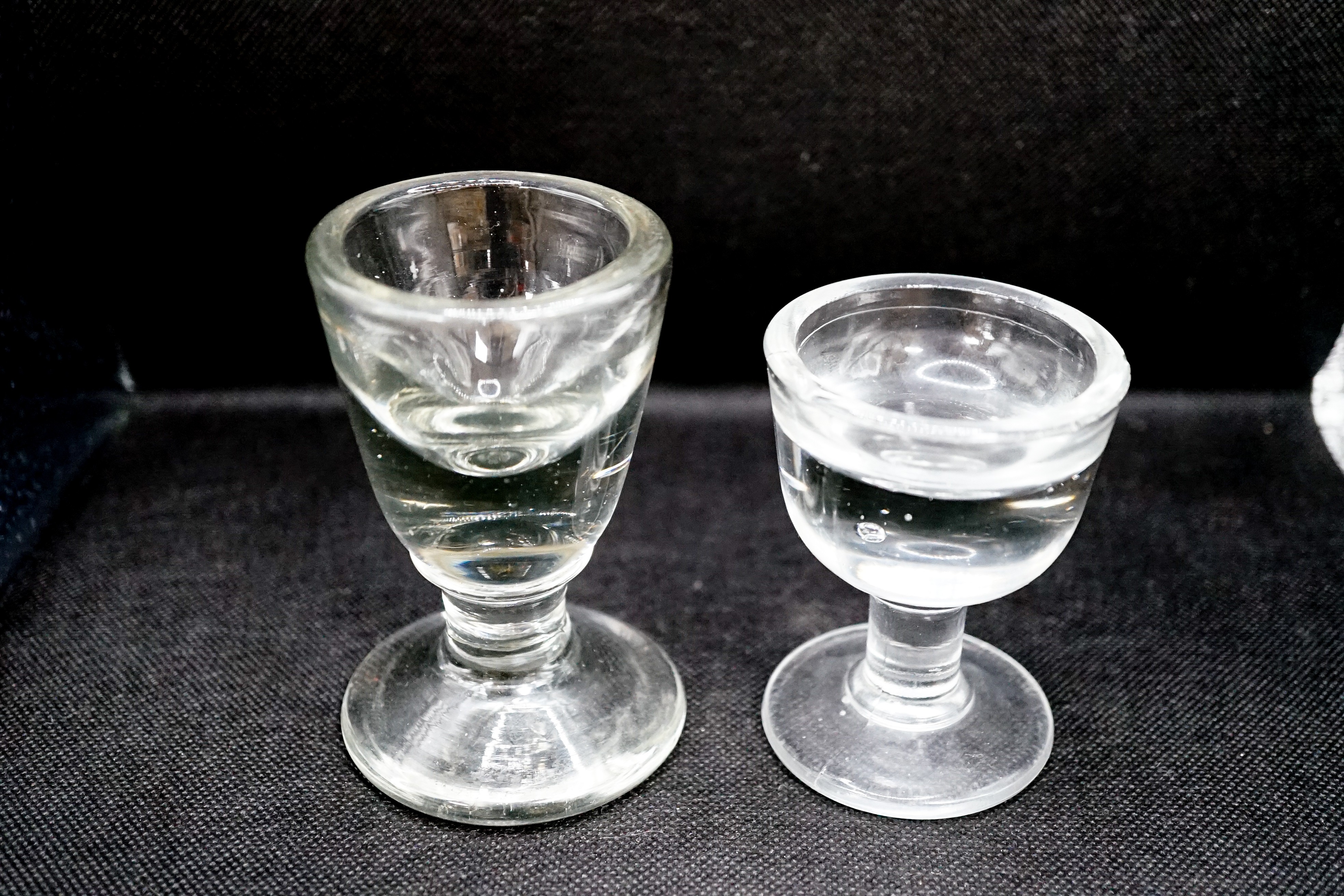 A Georgian deceptive Toastmasters glass and a later penny lick type glass, tallest 10 cm